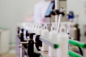 picture of lotion bottles on production line for a Private Label Cosmetics Company