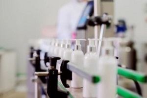 picture of lotion bottles on production line for a Private Label Cosmetics Company
