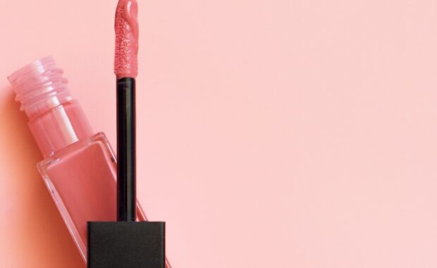 lipstick and applicator on pink color background